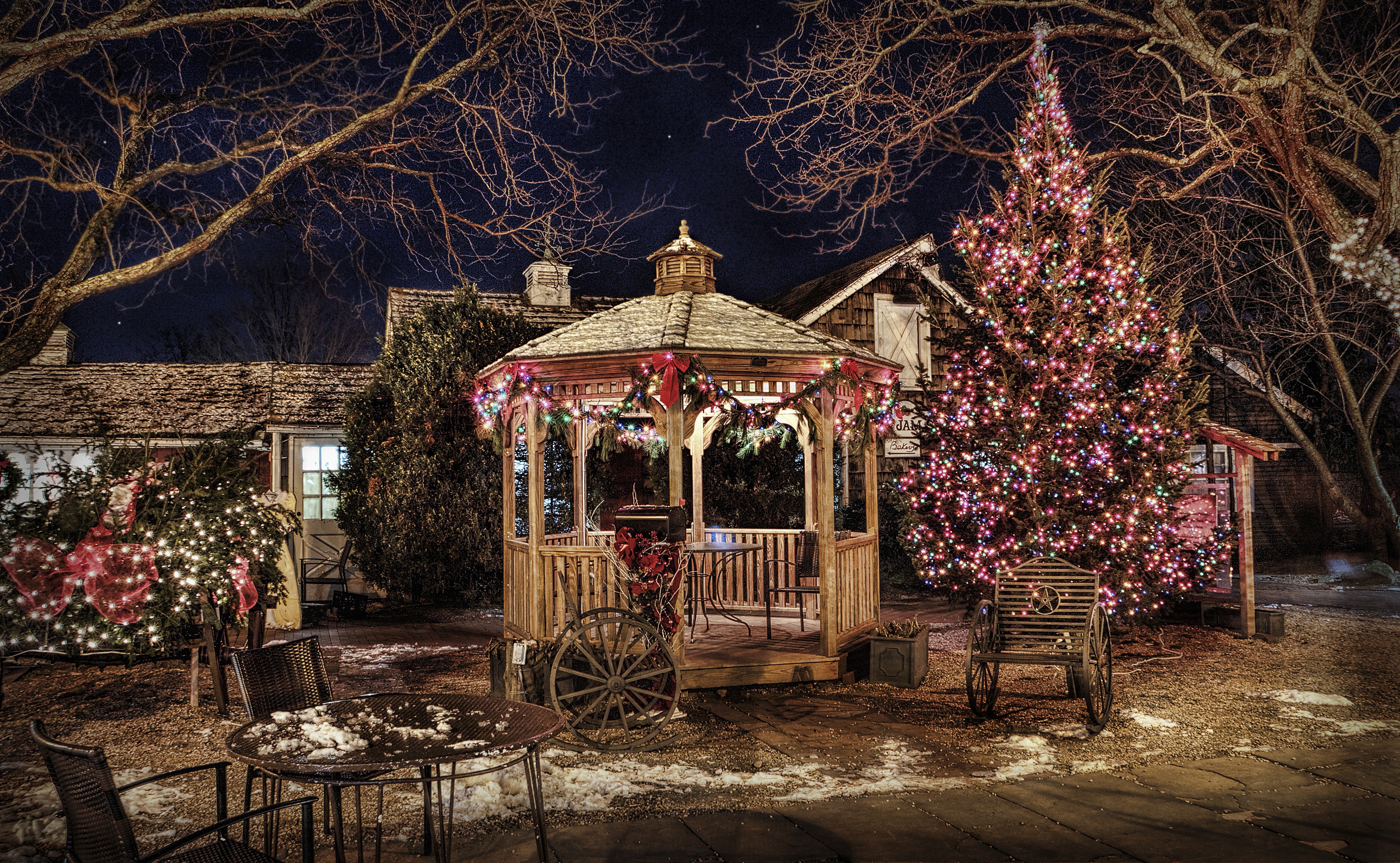 Luxury estate lit with festive tree and landscape lighting
