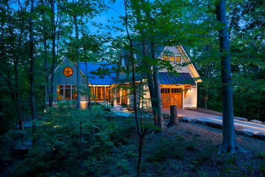 Sterling Lighting fixtures highlighting a landscaped residence at night